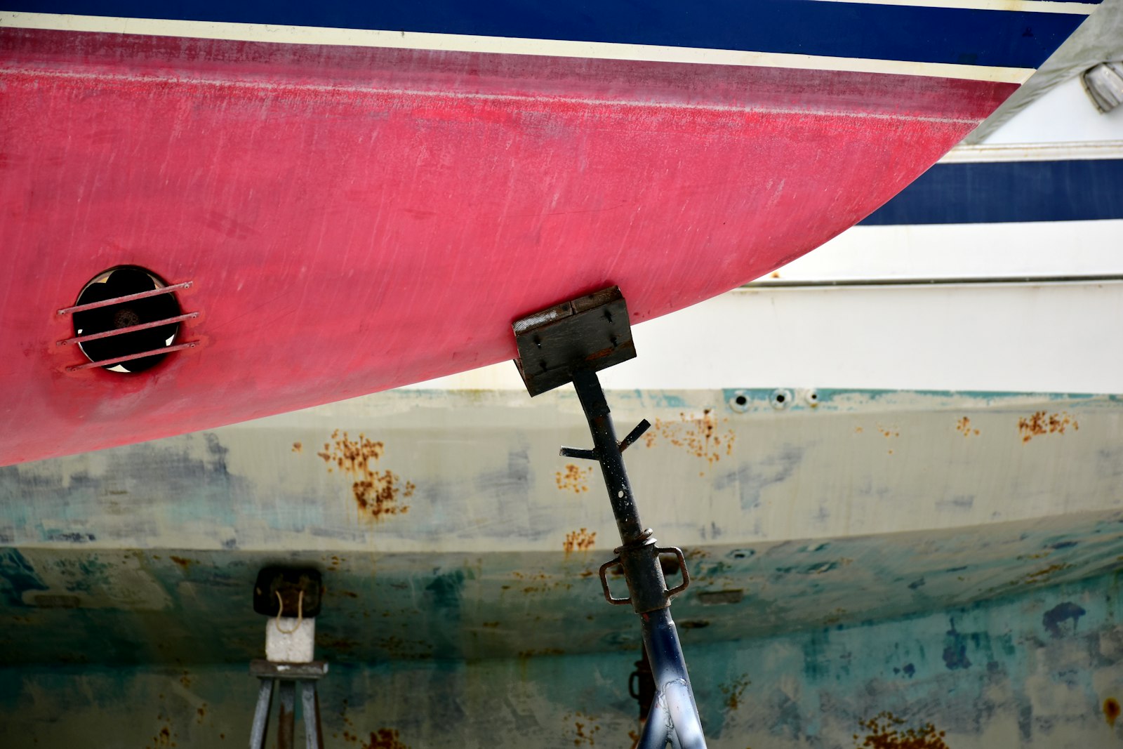 Antifouled hull, prop shaft and anode close up on the hard
