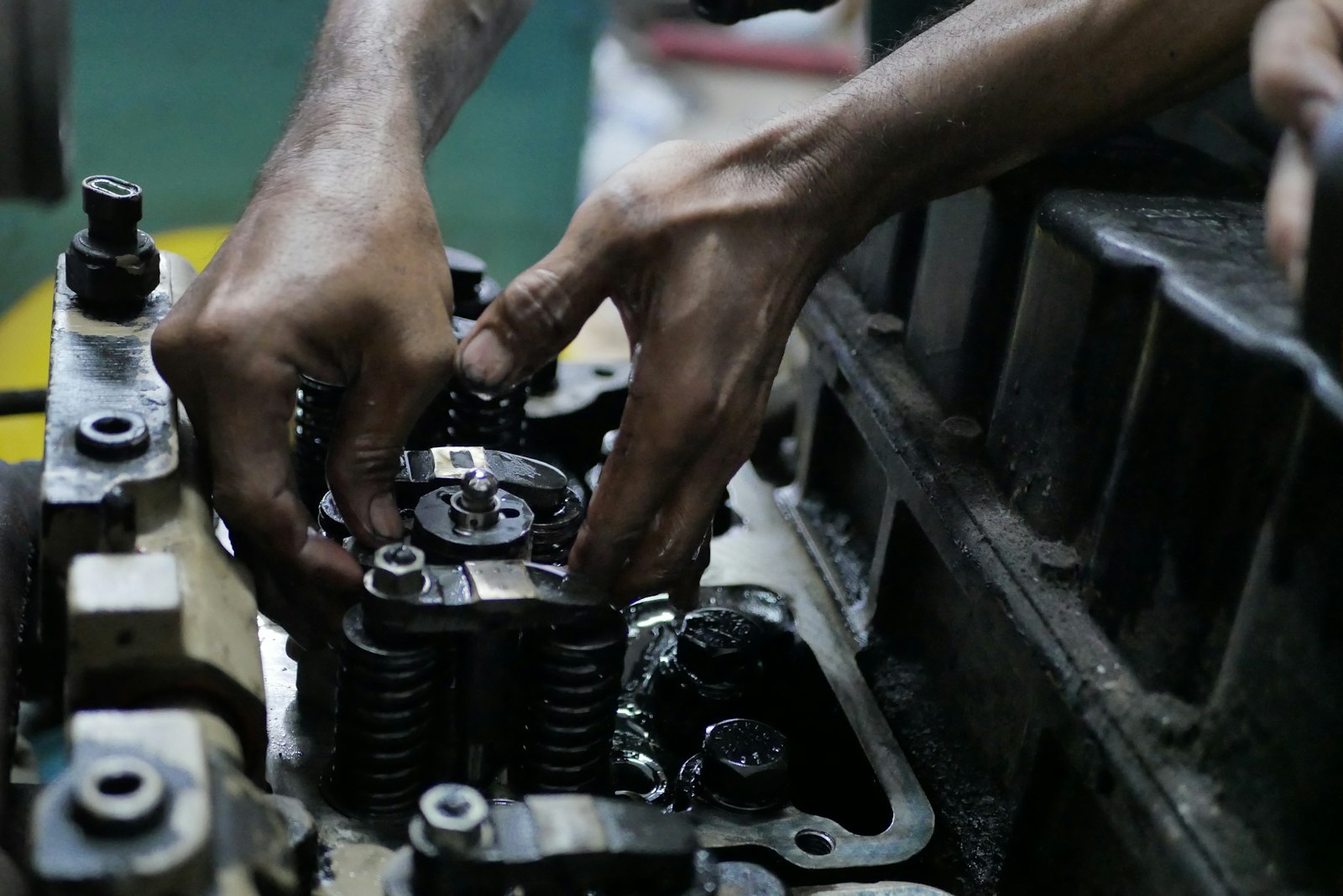 Hands stripping a gearbox cluster